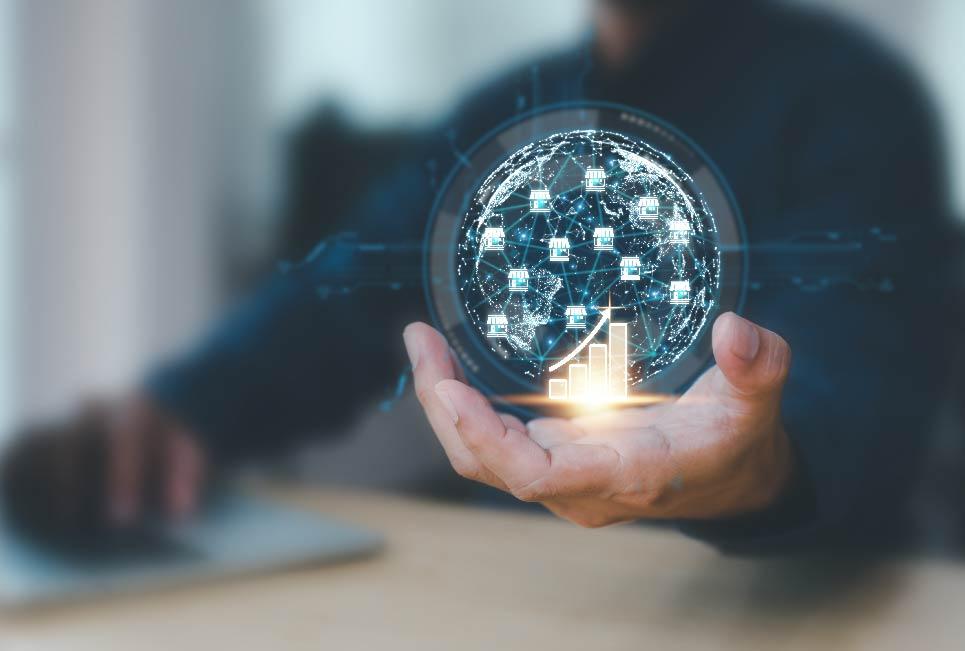 A man holds a laptop in one hand and a virtual globe with networking connection and a column chart in the other, symbolizing the fusion of technology and intellect.